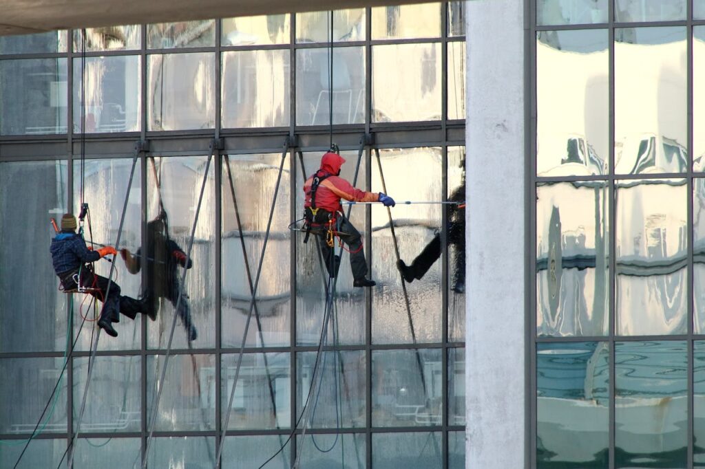 pexels-photo-8901934 Two People Cleaning Glass Windows of a Building
